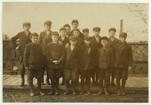 Group of young male mill workers